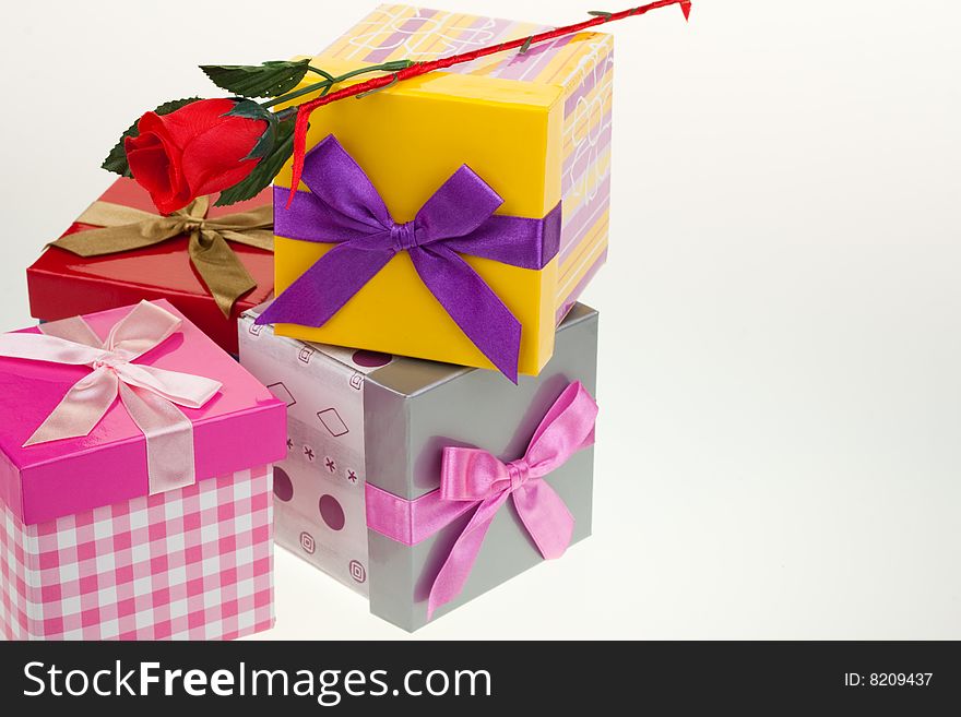 Various gift boxes on a white background, with bow and rose. Various gift boxes on a white background, with bow and rose