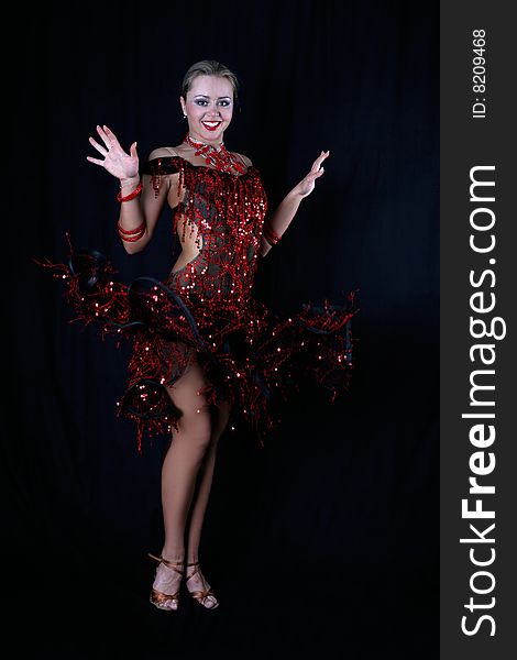 Latin dancer against black background