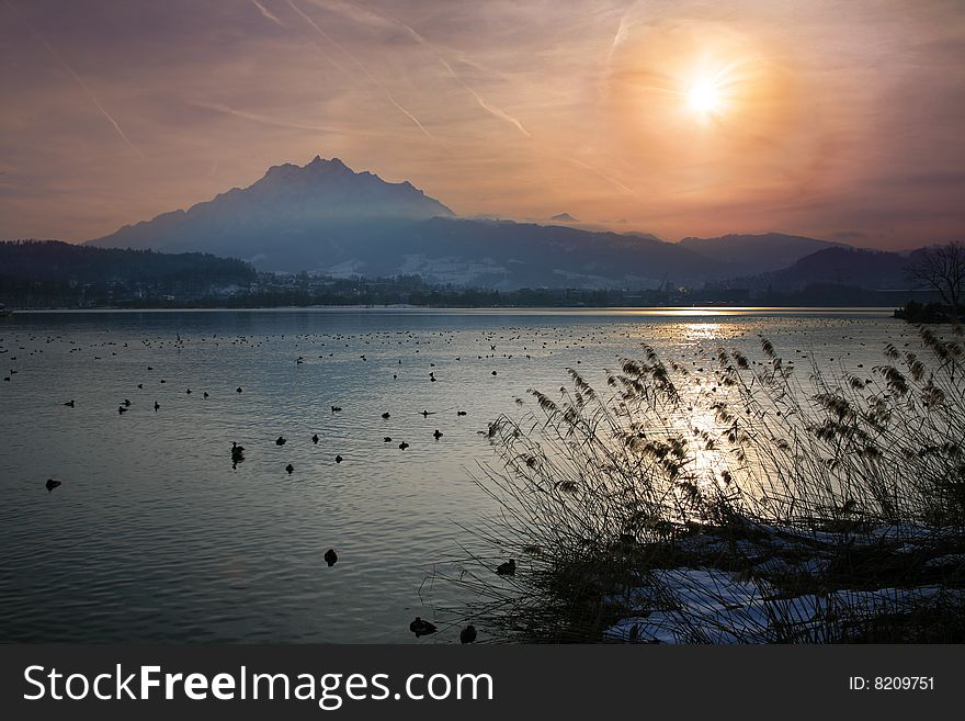 Winter Sun Over A Alpine Lake