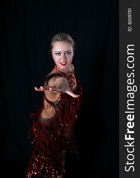 Lovely blonde latin dancer against black background