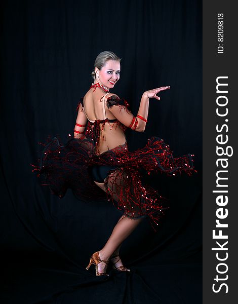 Lovely blonde latin dancer against black background