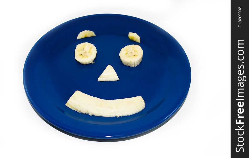 Isolated Banana Face on Blue Plate. Isolated Banana Face on Blue Plate