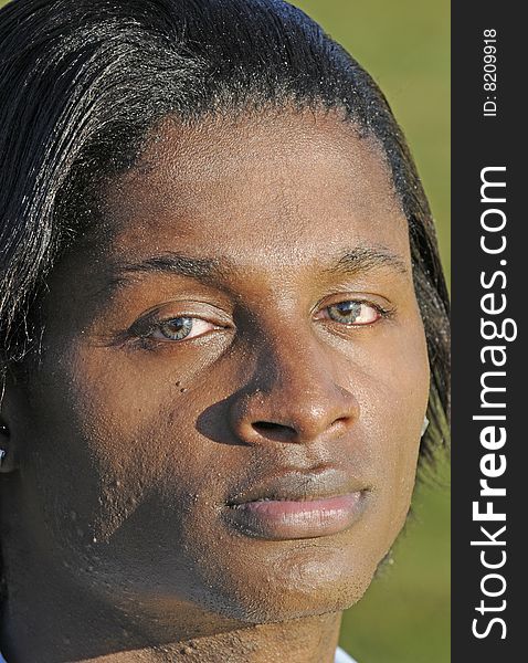 Closeup of a young African American man with bloodshot eyes from allergies