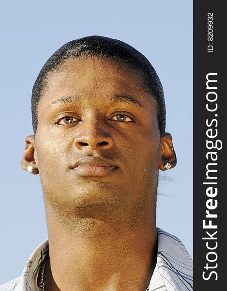 Young African American man isolated on a blue background