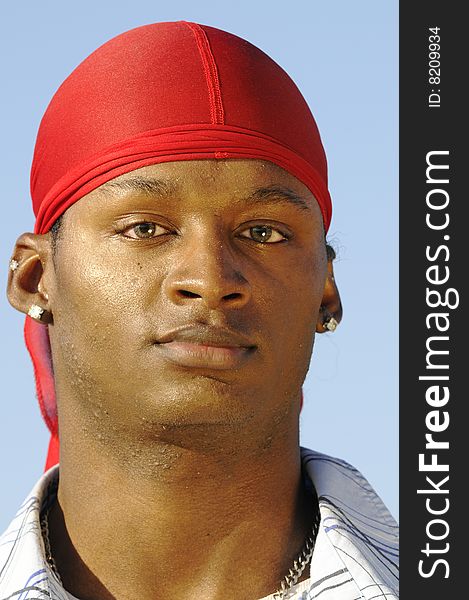 Young African American man isolated on a blue sky