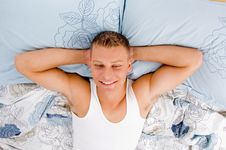 Vacation - Male Relaxing On His Bed Stock Photo