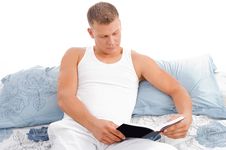 Reading Book - Male Reading In Bed Relaxing Stock Image Reading Book - Male Reading In Bed Relaxing Stock Image