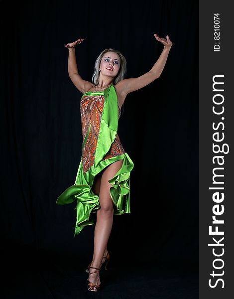 Lovely blonde latin dancer against black background