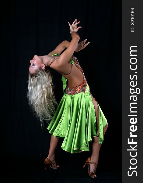 Latin dancer against black background