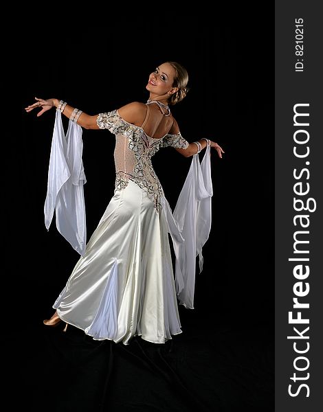 Dancer in classical blue-white dress against black background. Dancer in classical blue-white dress against black background