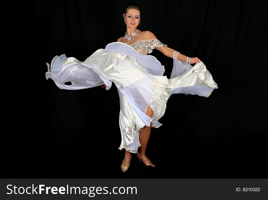 Blonde dancer in classical blue-white dress against black background