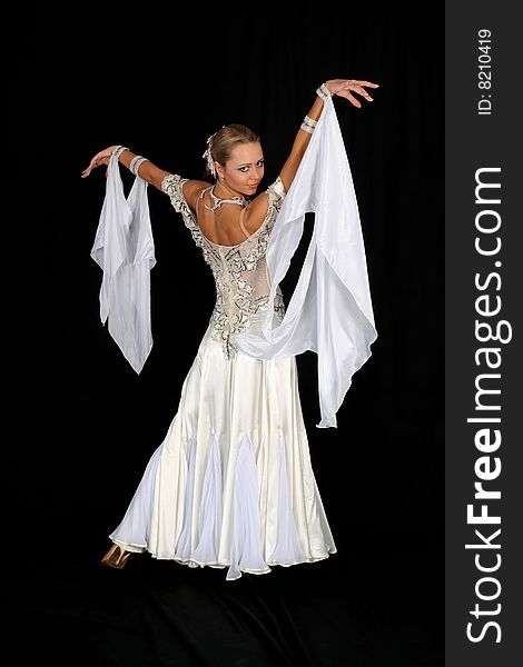 Dancer in classical blue-white dress against black background