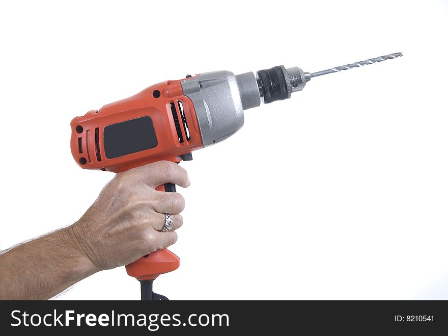 Hand holding large electric drill with white background. All logos and brand names removed. Hand holding large electric drill with white background. All logos and brand names removed.