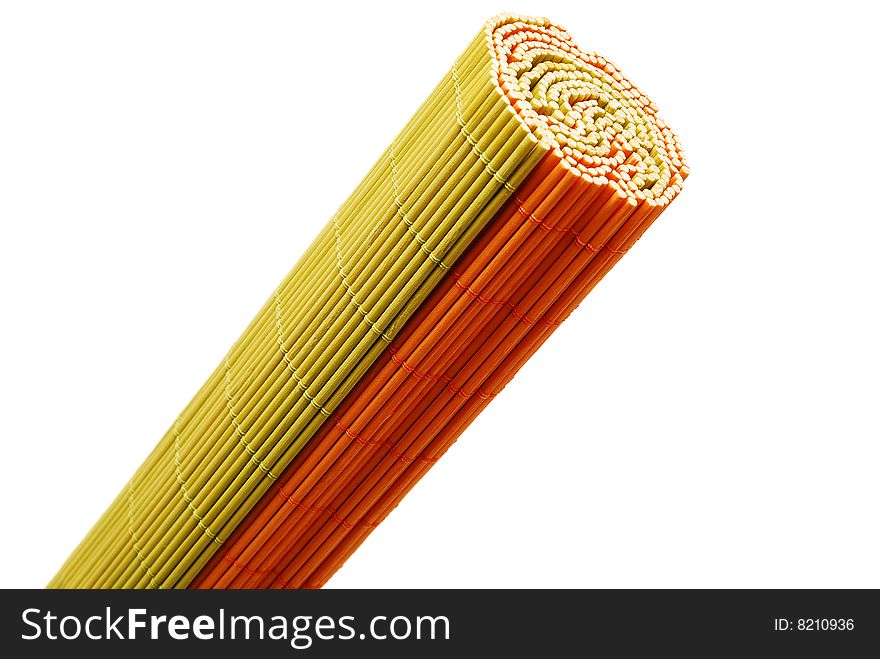 Two rolled bamboo mats over white background