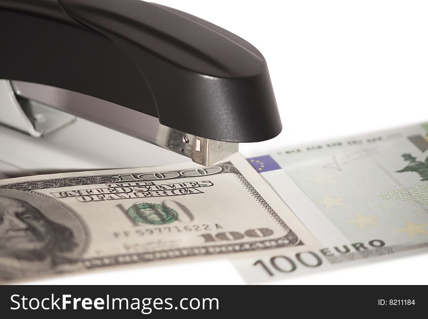 Stapler with stack of dollars and euros isolated on white background. Stapler with stack of dollars and euros isolated on white background