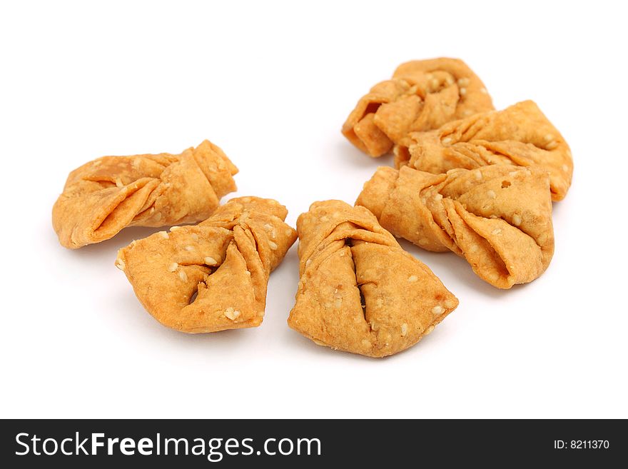 Sesame ribbon cookies isolated over white background.