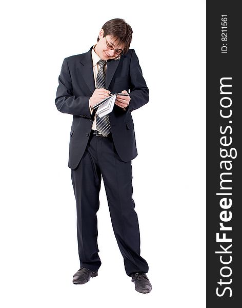 Young businessman calling by cellular phone and writes in a notebook. Over white