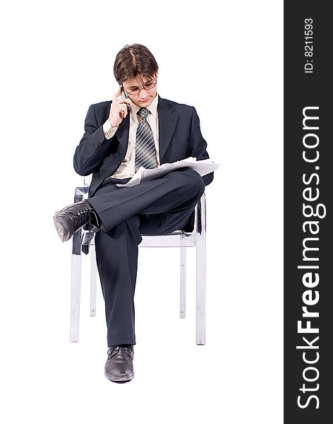 Young businessman looks documents and calling by cellular phone. Over white