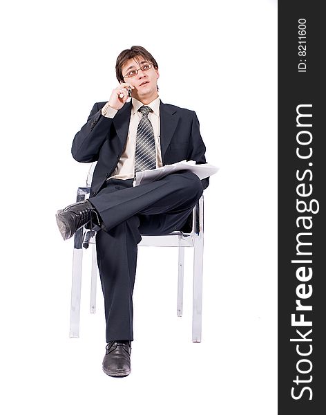 Young businessman looks documents and calling by cellular phone. Over white. Young businessman looks documents and calling by cellular phone. Over white