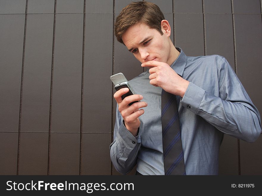 Businessman checking Messages on cell phone