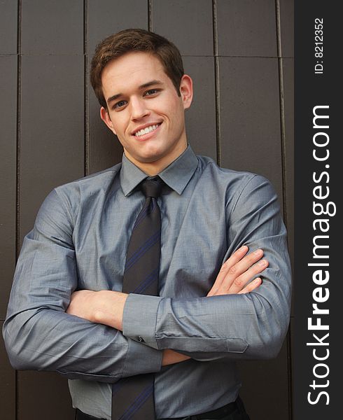 Confident young Businessman smiling with arms crosssed. Confident young Businessman smiling with arms crosssed