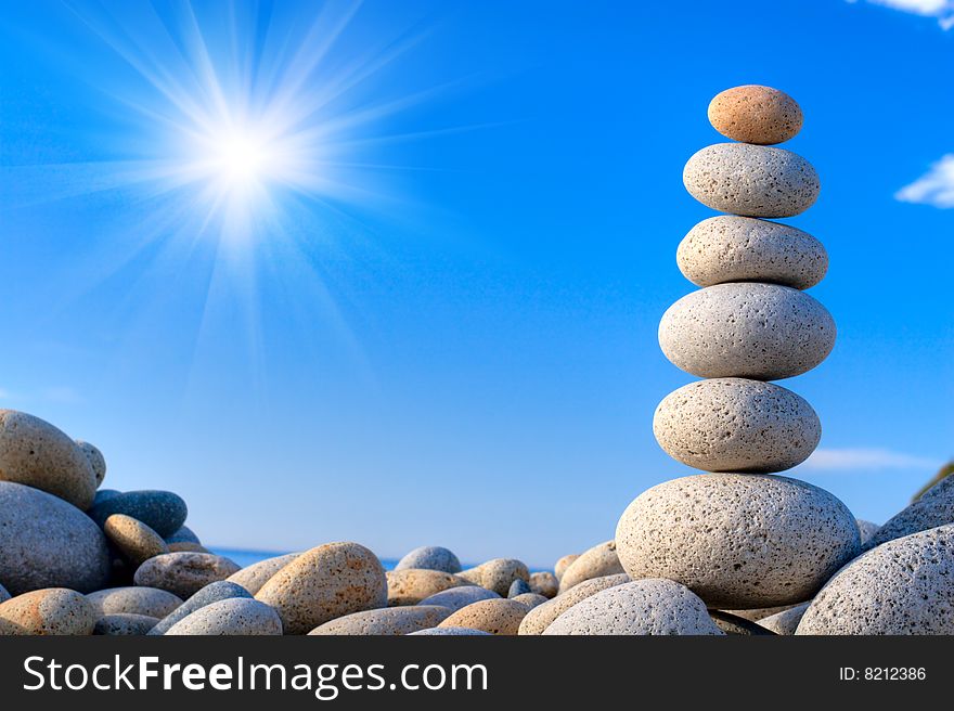 Round stones on a background of blue sky