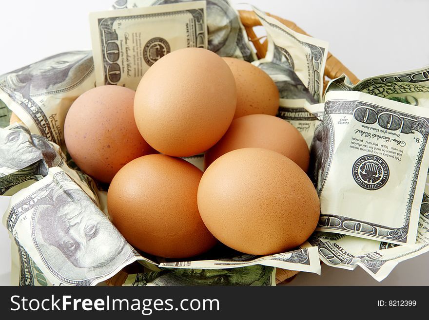 Conceptual saving images; eggs in basket of 100 dollar bills. Conceptual saving images; eggs in basket of 100 dollar bills.