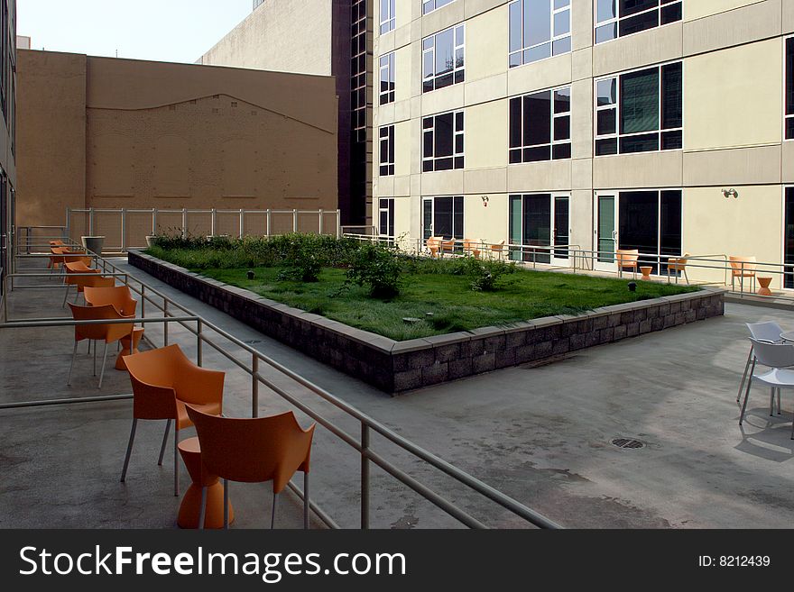 A modern loft courtyard with tables and chairs