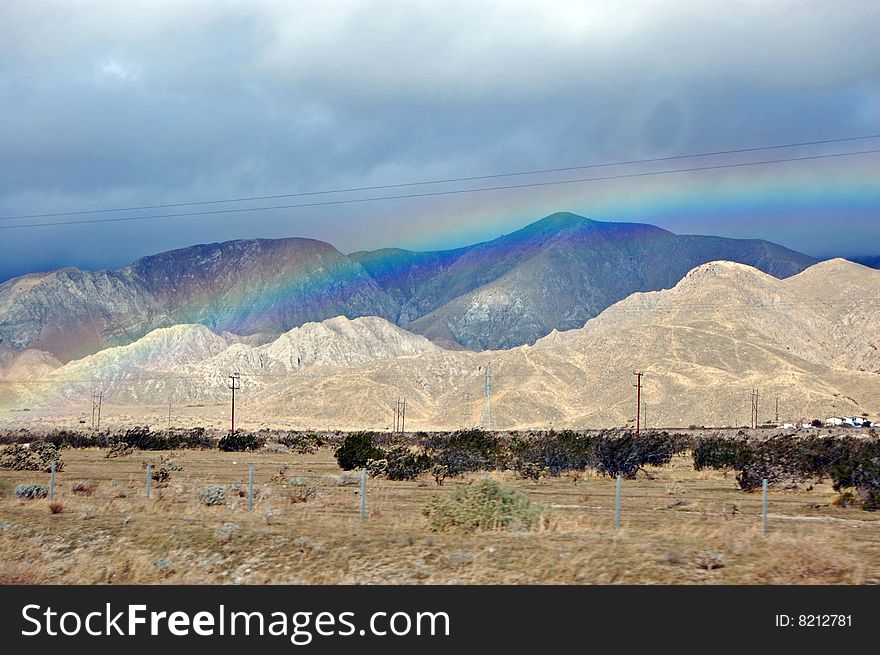 Its a rainbow by the mountains. Its a rainbow by the mountains.