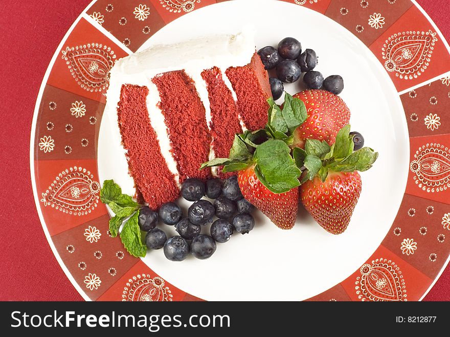 A Slice Of Elegant Red Velvet Cake With Fruit