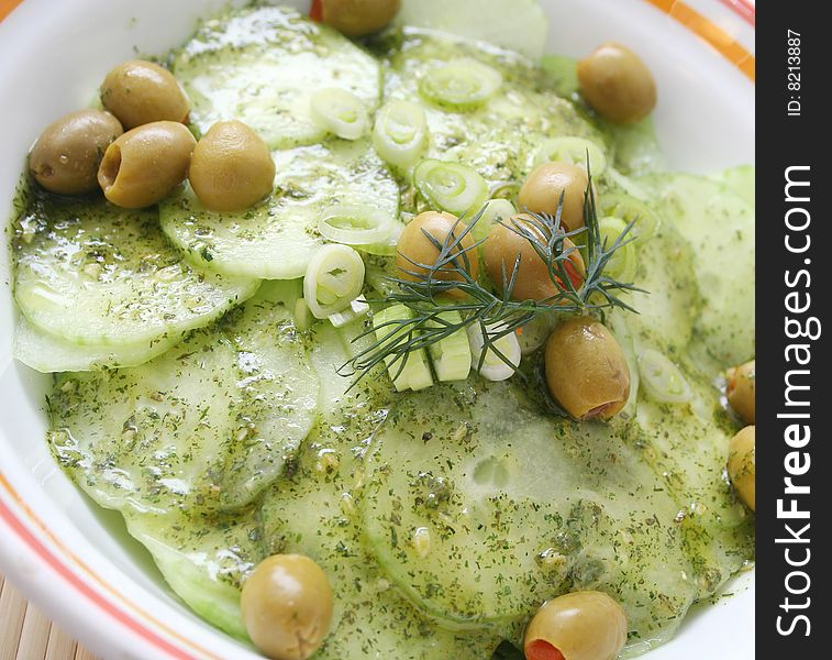Fresh salad of cucumbers with spices and olives