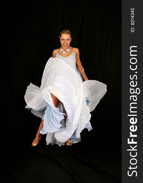 Dancer in classical blue-white dress against black background. Dancer in classical blue-white dress against black background