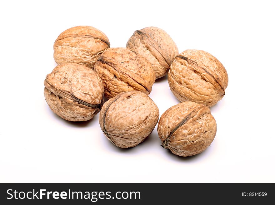 Some nuts laying on a white background