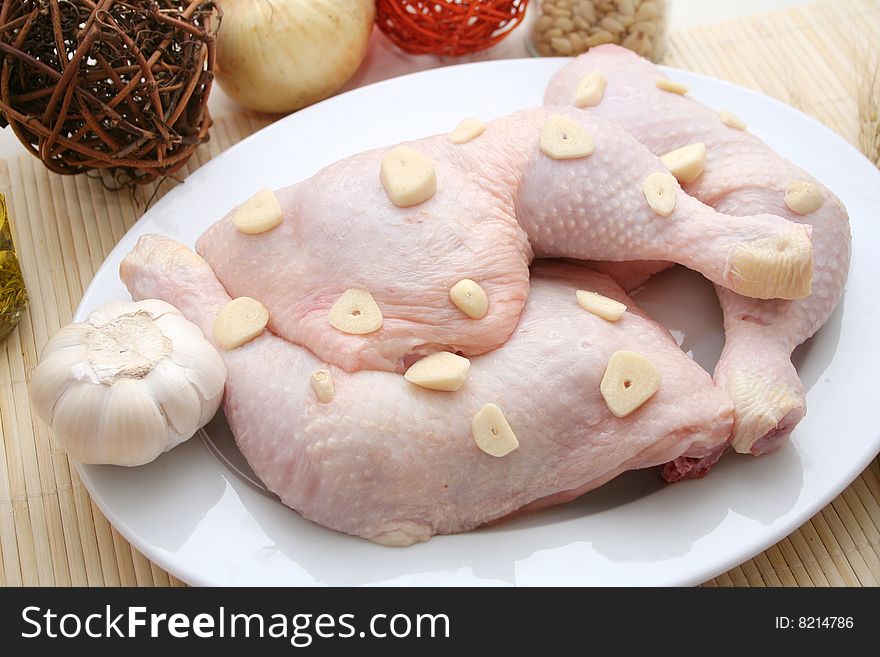 Fresh chicken meat with garlic on a plate