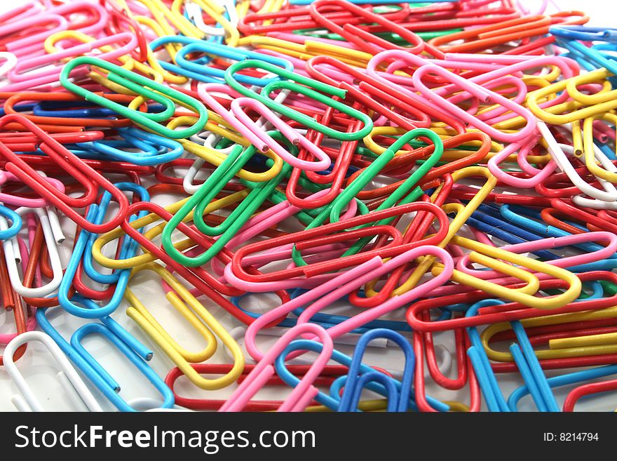 Many multi-coloured paper clips for a paper