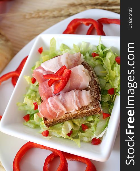 A fresh breakfast of salad with bread and ham