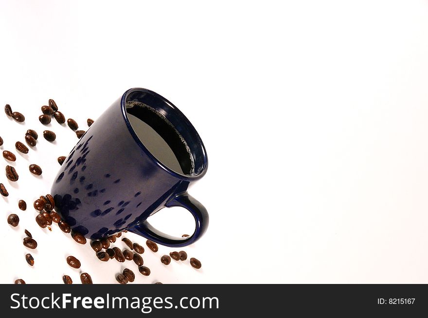 Isolated coffee with beans spread out. Isolated coffee with beans spread out