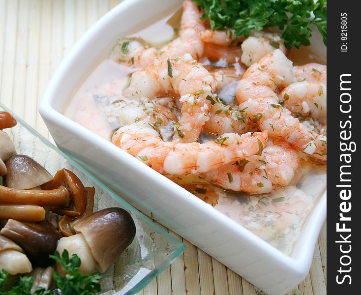 A snack of prawns in garlic oil and mushrooms