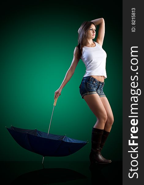 Dynamic image of a beautiful woman shot in studio with an umbrella. Dynamic image of a beautiful woman shot in studio with an umbrella