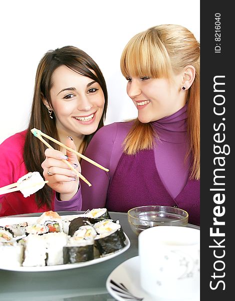 Womans eating  sushi