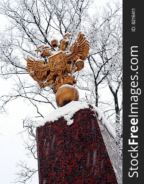 Double eagle on granitic pedestal under snowfall. Double eagle on granitic pedestal under snowfall.