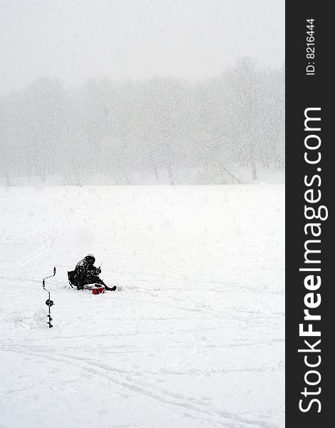 Winter fisherman, and heavy snowfall. Very strong weather. Winter fisherman, and heavy snowfall. Very strong weather.