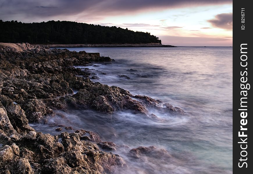 Sunset on the beach.Rocky Adriatic coast on the island Losinj, Croatia. This portfolio contains mono toned version of this image. Sunset on the beach.Rocky Adriatic coast on the island Losinj, Croatia. This portfolio contains mono toned version of this image.