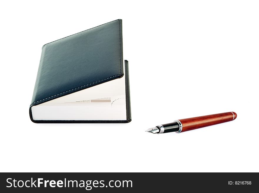 Notepad with  fountain pen  on white background. Notepad with  fountain pen  on white background