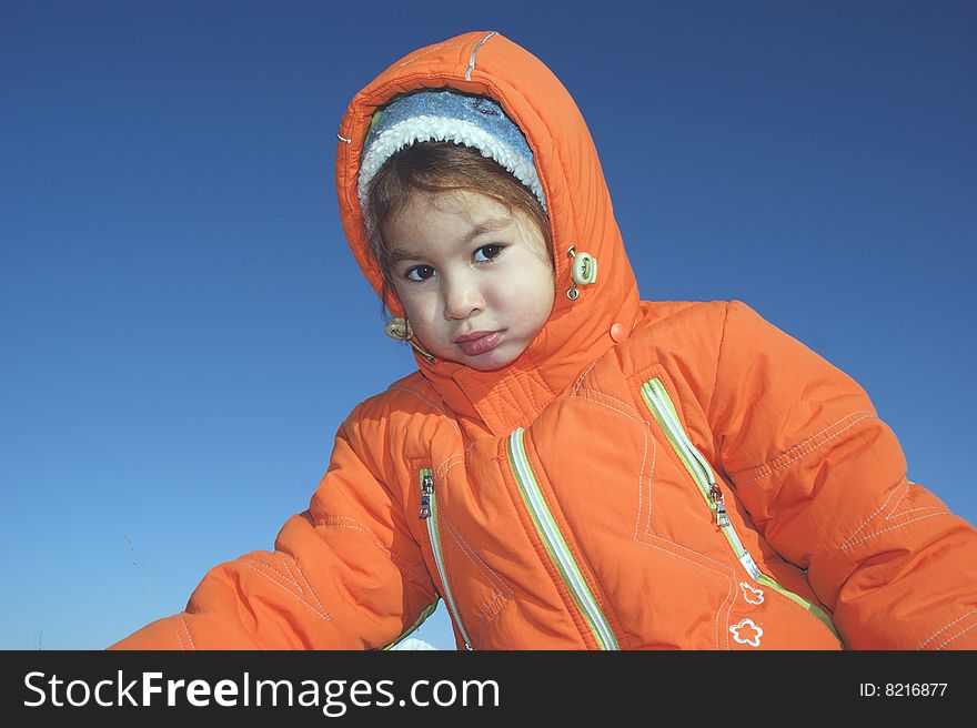 Child in their own daydream on background blue sky