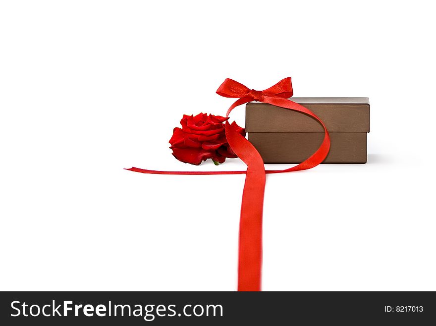 Gift box with red rose and ribbon over a white background