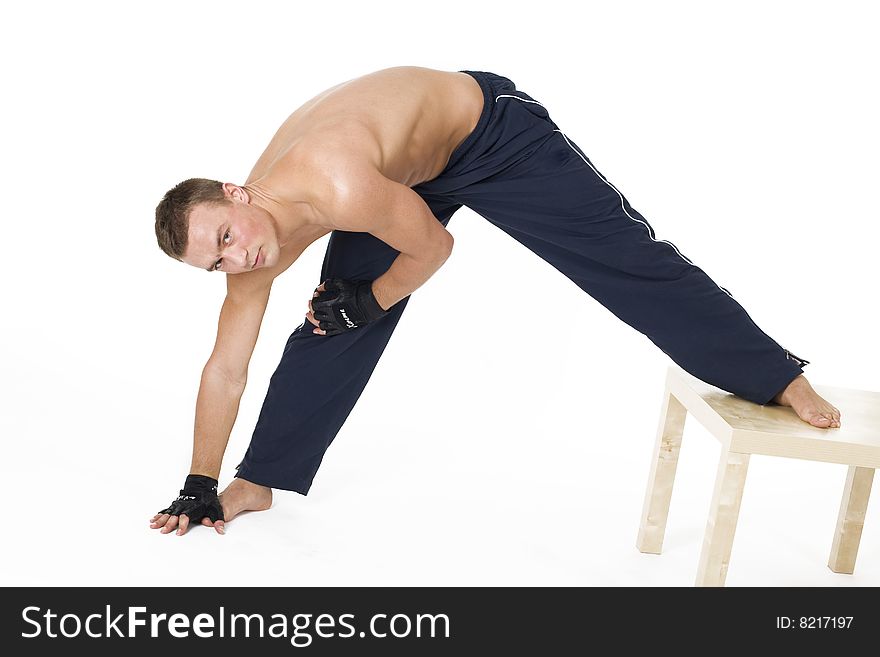 Handsome man stretching over white background