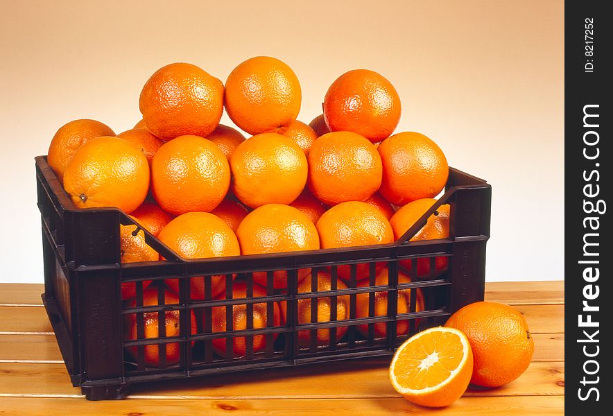 Oranges on a table made of wood.