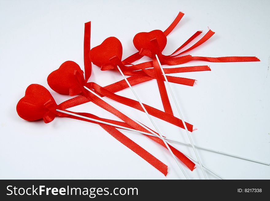 Some hearts with ribbons on white background