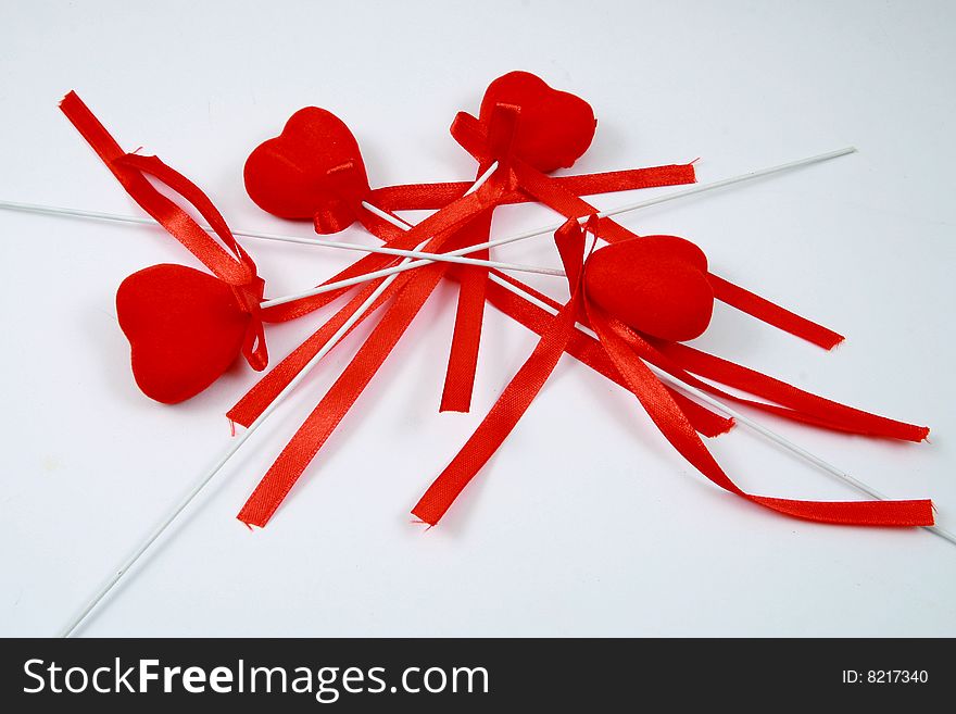 Some hearts with ribbons on white background